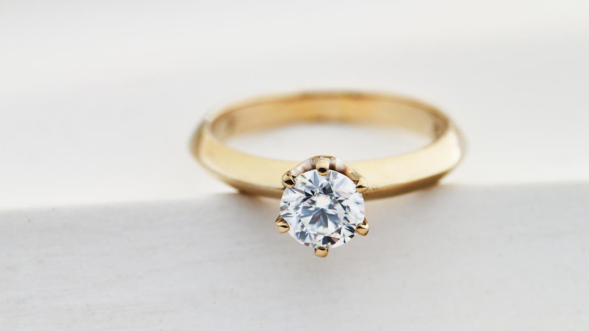 Gold ring with diamond on white backgroundGold ring with diamond on white background